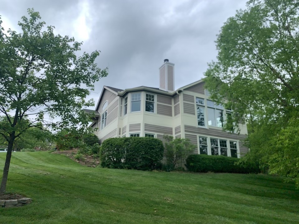 A two-story house with lap siding and white trim