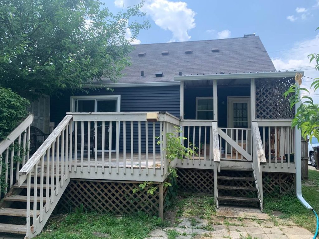 A rear porch and deck with doors